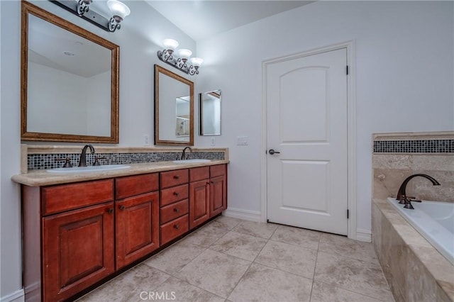 bathroom featuring tile patterned flooring, vanity, and tiled bath