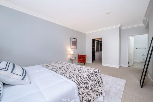 carpeted bedroom featuring a spacious closet, a closet, and ornamental molding