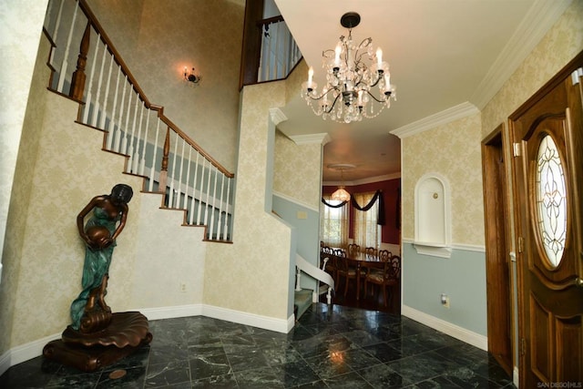 foyer entrance with an inviting chandelier, ornamental molding, and a wealth of natural light