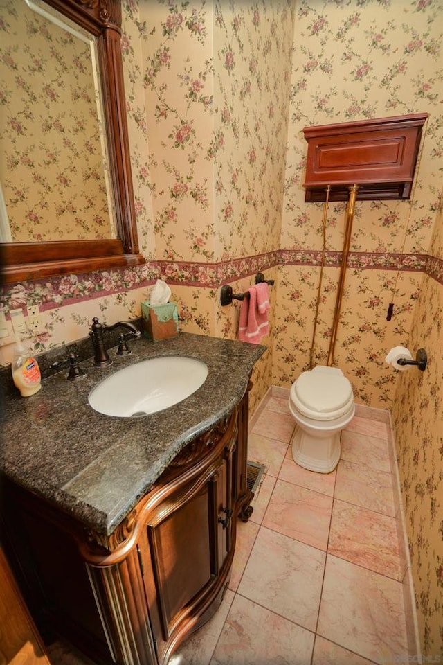 bathroom featuring tile patterned flooring, vanity, and toilet