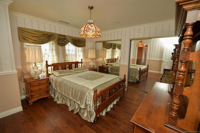 bedroom featuring ornamental molding and dark hardwood / wood-style flooring