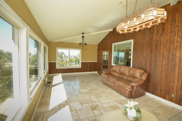 sunroom / solarium featuring lofted ceiling