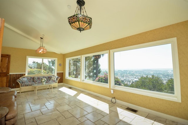 unfurnished sunroom with a healthy amount of sunlight and lofted ceiling