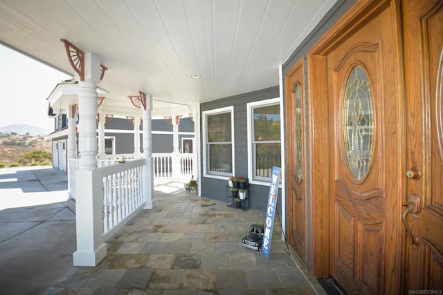 exterior space with a mountain view and covered porch