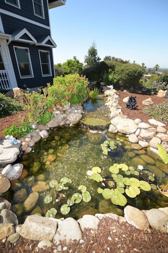 view of yard with a small pond