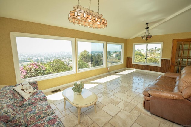 living room with a healthy amount of sunlight and lofted ceiling