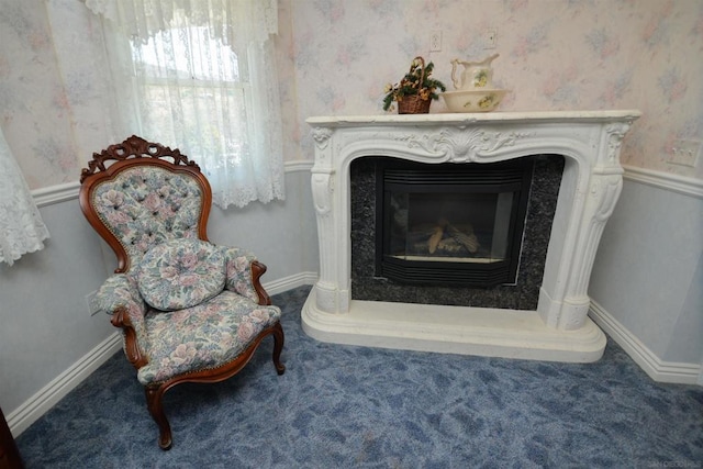 sitting room featuring a high end fireplace and carpet flooring