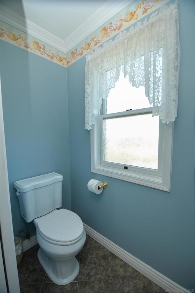 bathroom with ornamental molding, toilet, and tile patterned floors