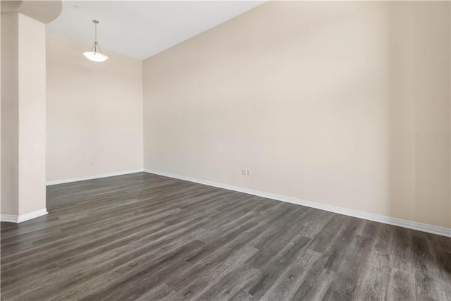 spare room with dark hardwood / wood-style floors