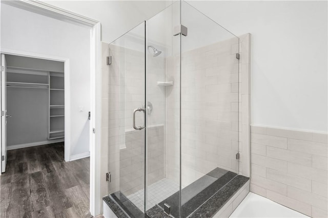 bathroom featuring independent shower and bath and wood-type flooring