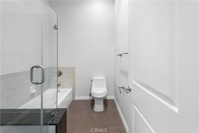 bathroom featuring hardwood / wood-style flooring, toilet, and shower with separate bathtub