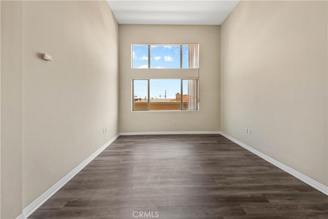 spare room featuring dark wood-type flooring