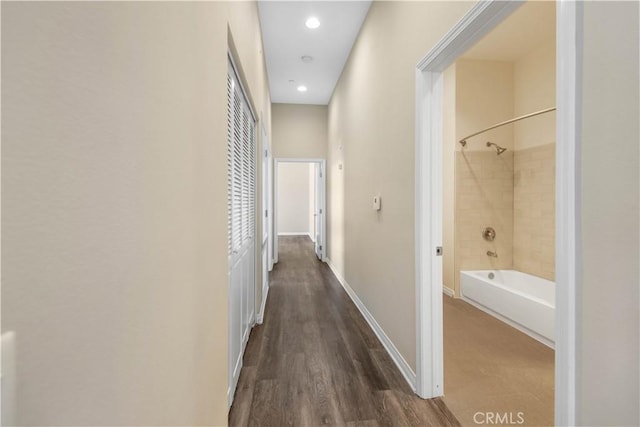 corridor with dark hardwood / wood-style flooring