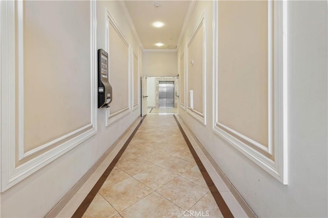 hall with light tile patterned floors and ornamental molding