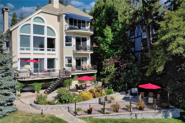 rear view of property featuring a patio area