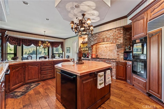 kitchen featuring an inviting chandelier, dark hardwood / wood-style floors, and a center island