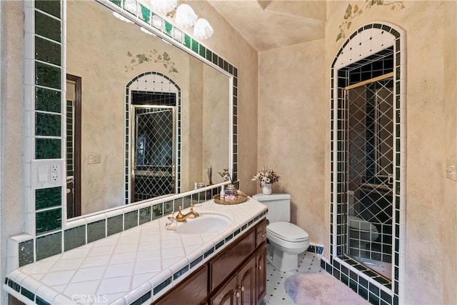 bathroom featuring toilet, tile patterned floors, and vanity