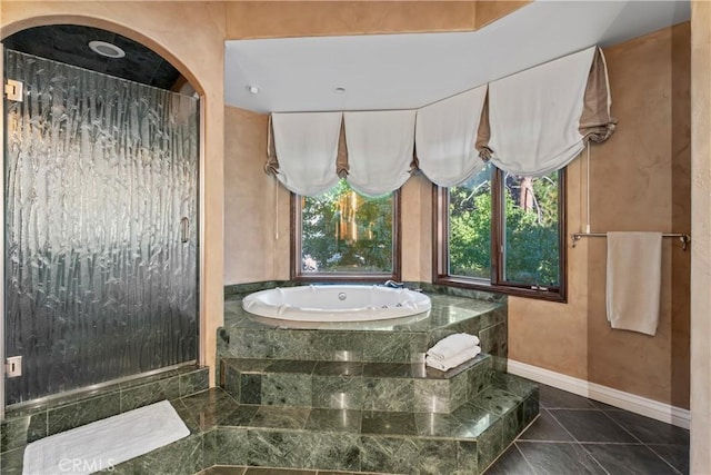 bathroom featuring tile patterned flooring and shower with separate bathtub