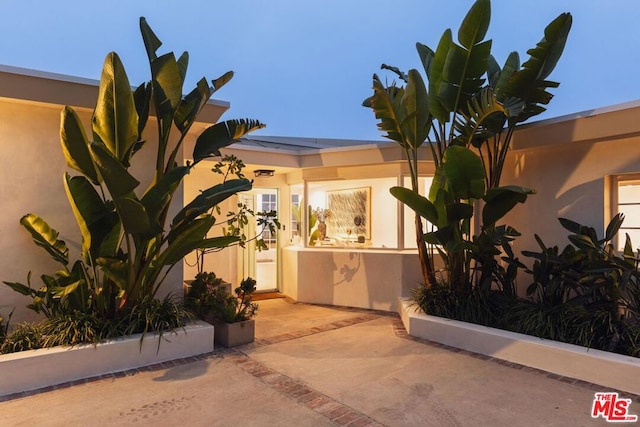 entrance to property featuring a patio