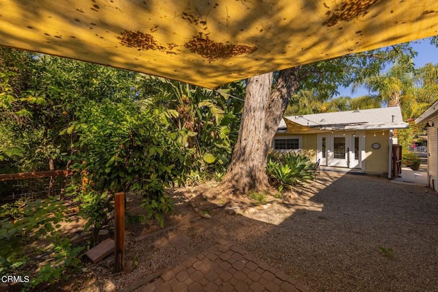 view of yard featuring french doors and a patio