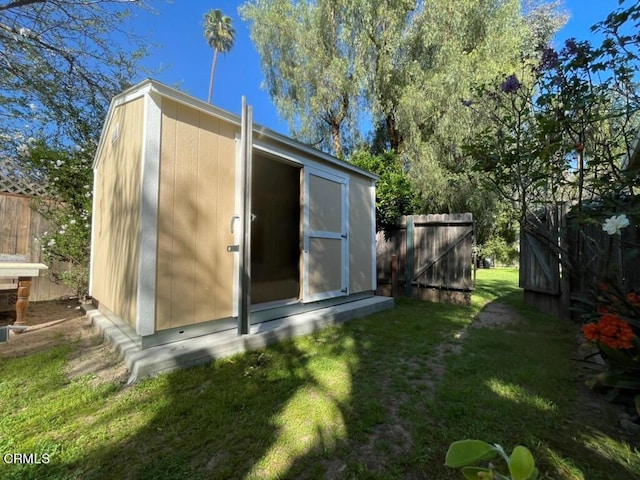 view of outdoor structure featuring a lawn