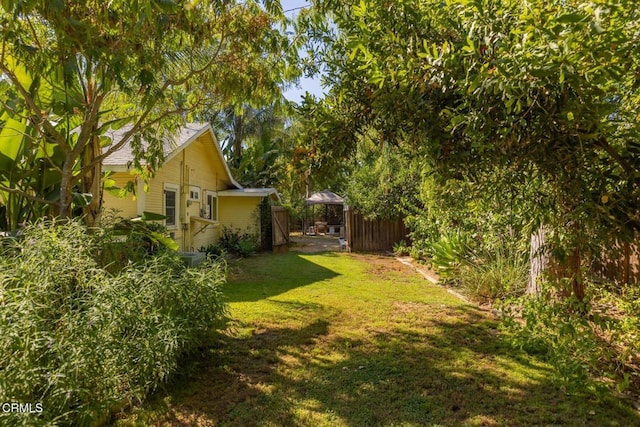 view of yard featuring fence and a gazebo