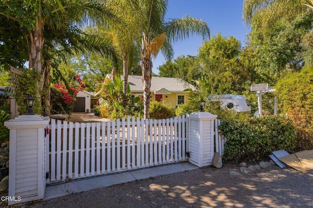 view of gate with a fenced front yard