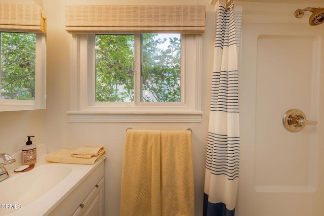 full bathroom with a shower with shower curtain, vanity, and a wealth of natural light