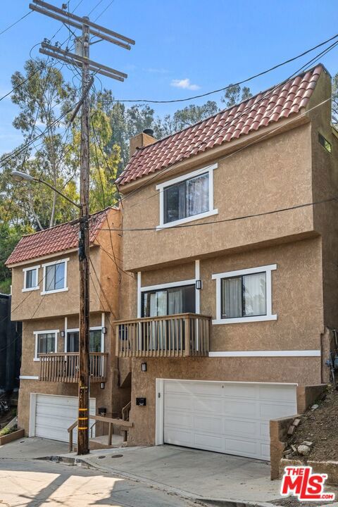 view of front of home featuring a balcony and a garage