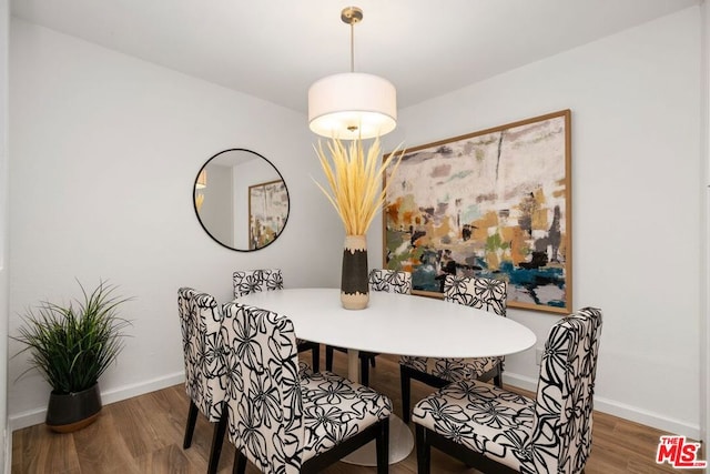 dining space with hardwood / wood-style flooring