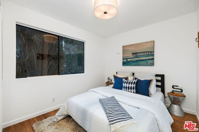 bedroom with wood-type flooring