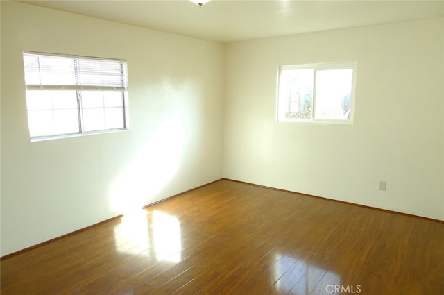 empty room with hardwood / wood-style floors