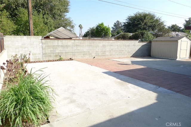 view of patio / terrace featuring a storage shed