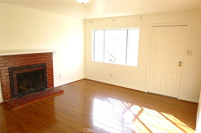 unfurnished living room with wood-type flooring and a fireplace