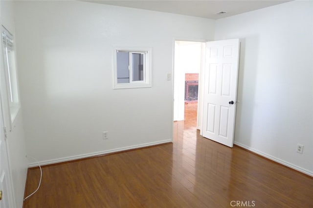 unfurnished room featuring dark hardwood / wood-style flooring