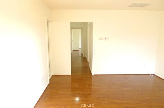 unfurnished room with dark wood-type flooring