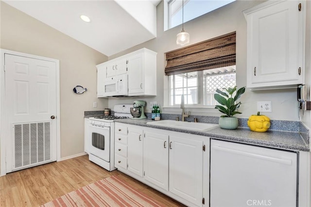 1169 Aztec, Topanga, CA 90290 - kitchen with white appliances, a sink, white cabinets, light wood-style flooring, and hanging light fixtures