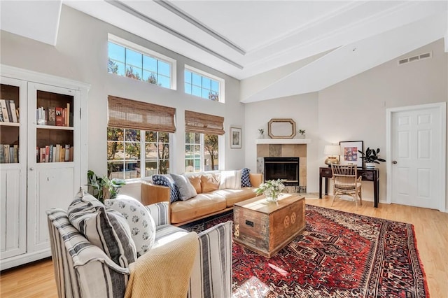 1169 Aztec, Topanga, CA 90290 - living area with a tile fireplace, light wood-type flooring, and high vaulted ceiling