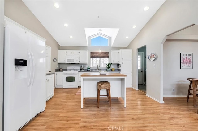 1169 Aztec, Topanga, CA 90290 - kitchen with white appliances, a sink, white cabinetry, lofted ceiling, and light wood-style flooring