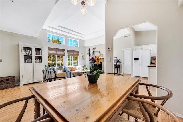 1169 Aztec, Topanga, CA 90290 - dining space featuring a towering ceiling, light wood finished floors, and a tray ceiling