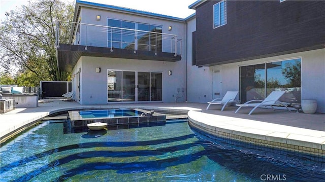 view of pool featuring a patio area and an in ground hot tub