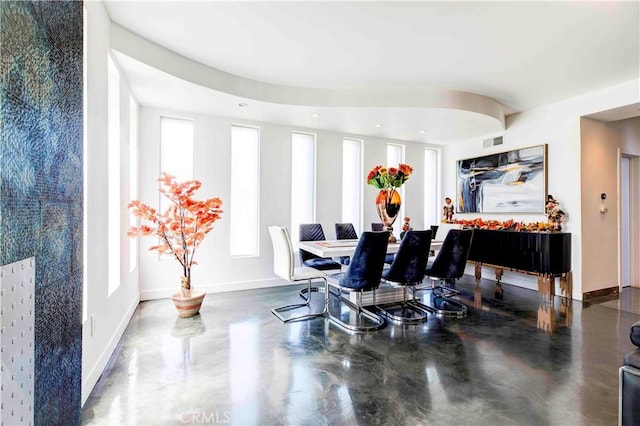 dining area featuring concrete flooring