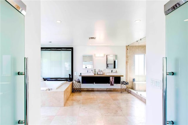 bathroom with vanity and separate shower and tub