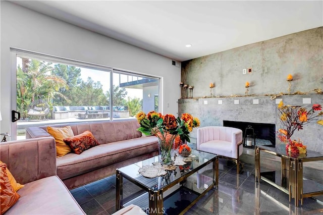 living room with a premium fireplace and a wealth of natural light