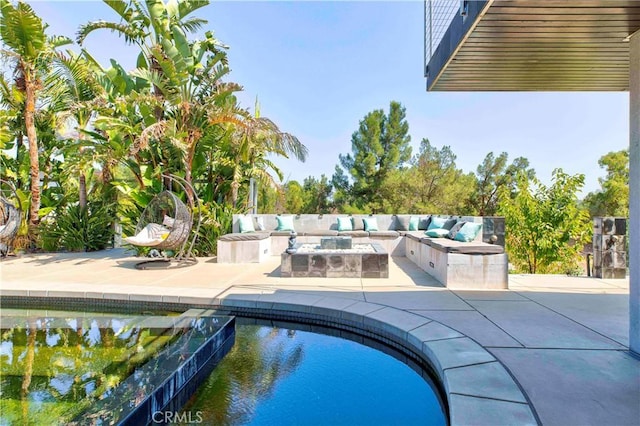 view of swimming pool featuring a patio area and an outdoor fire pit