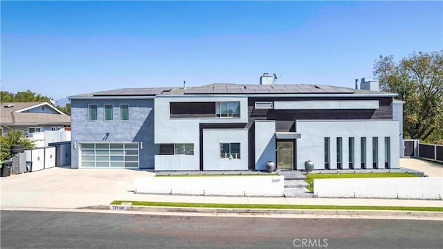 view of front of house with solar panels and a garage