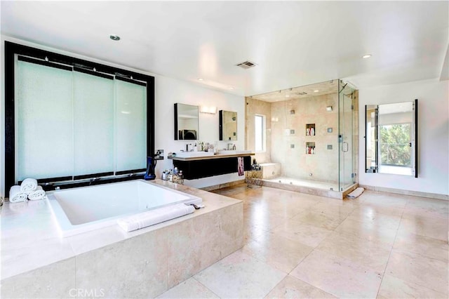 bathroom with vanity and separate shower and tub