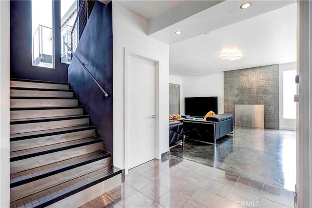 staircase with tile patterned floors and a wealth of natural light