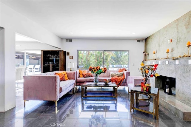 living room featuring a wealth of natural light and a premium fireplace