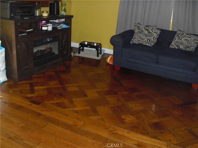 living room featuring dark parquet floors